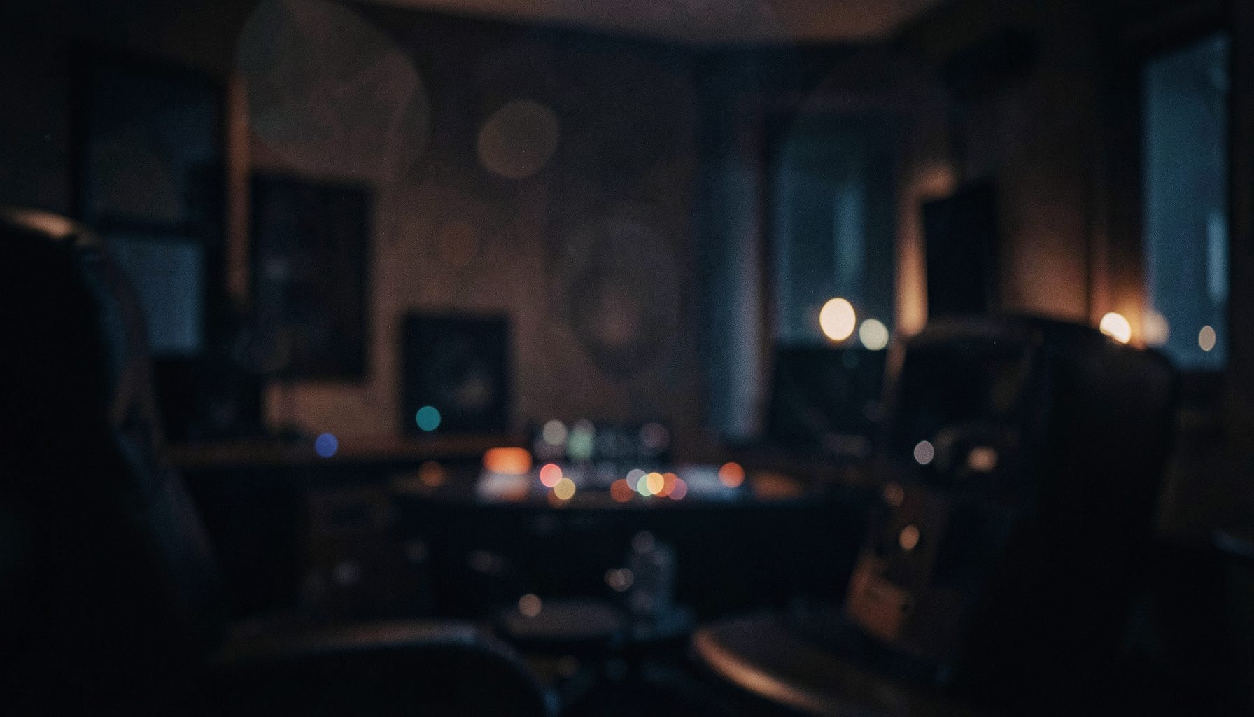 Rich burgundy and charcoal tones with soft bokeh circles suggesting a late-night listening room