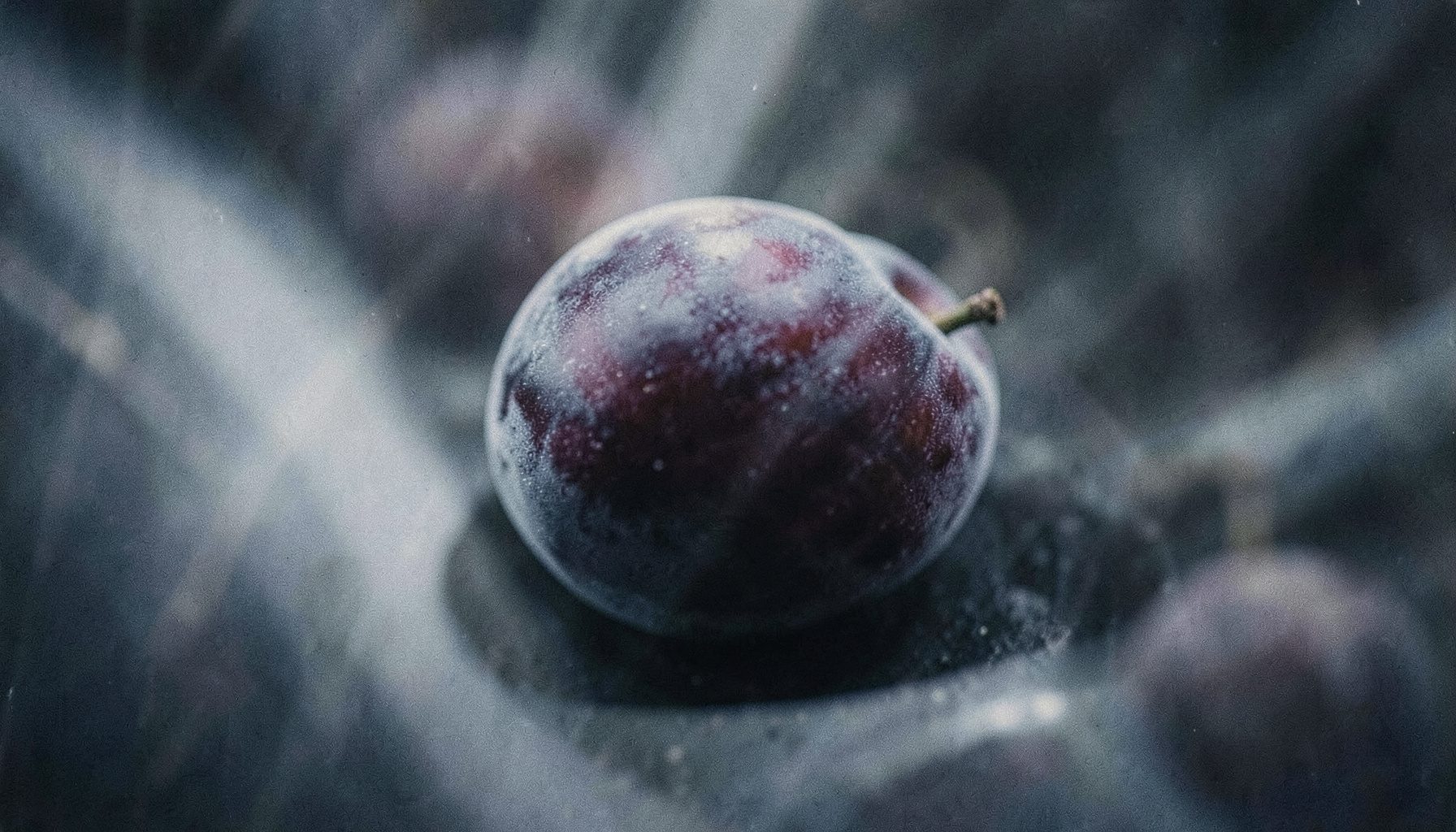 Soft plum and slate gray tones with gentle light streaks evoking a vintage vinyl aesthetic